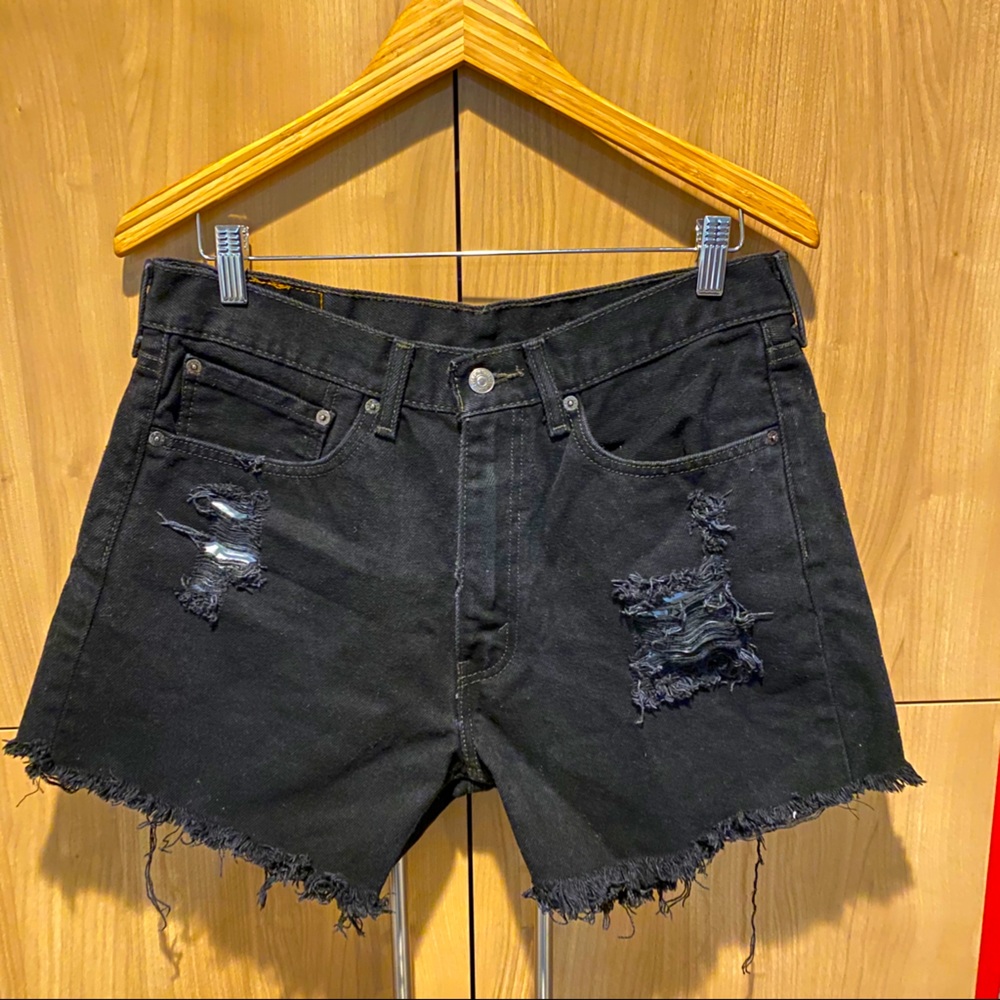 Levi’s distressed black denim cutoff shorts